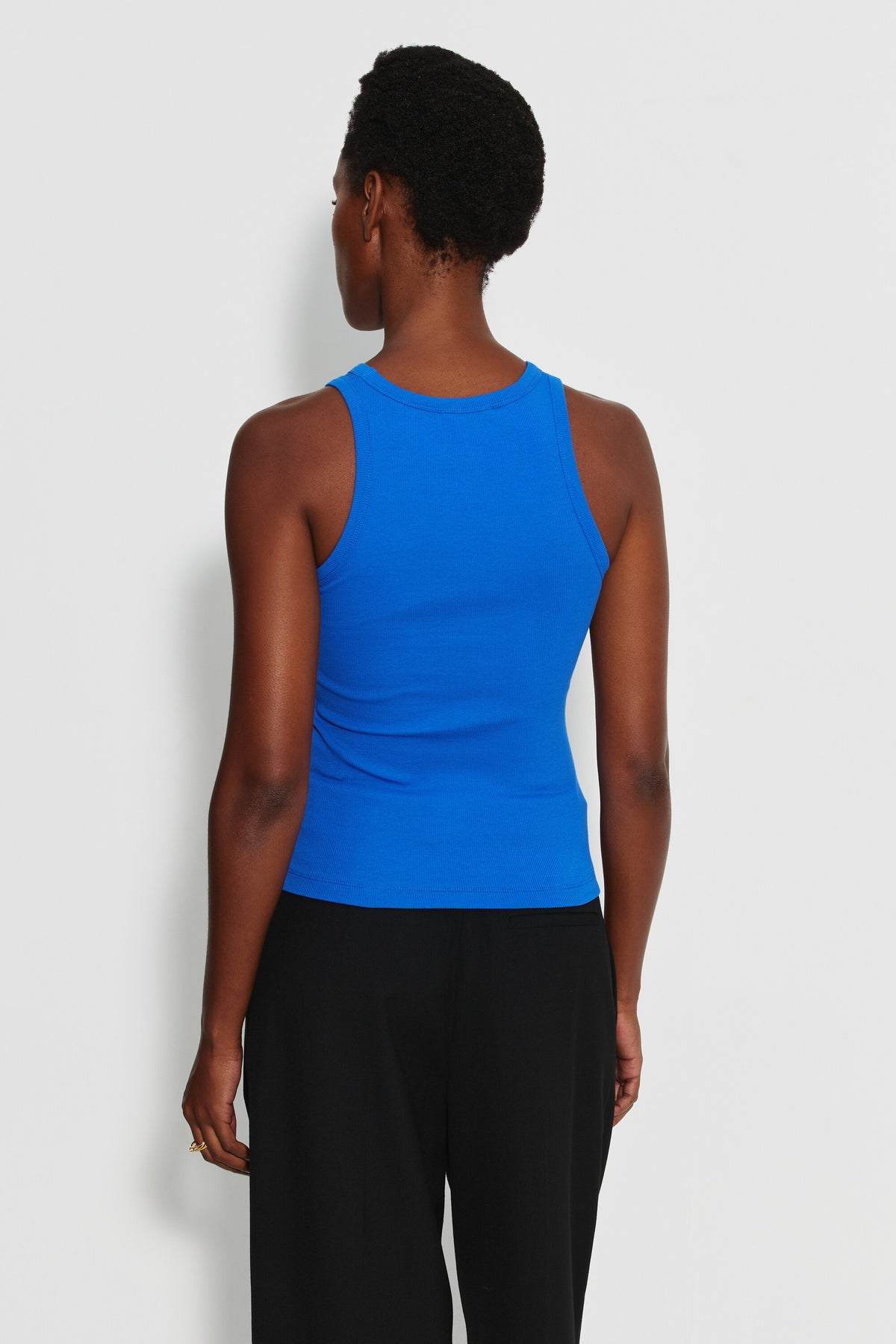 Débardeur Top Marcel bleu femme en coton Pima et élasthanne, porté de dos avec un pantalon noir.