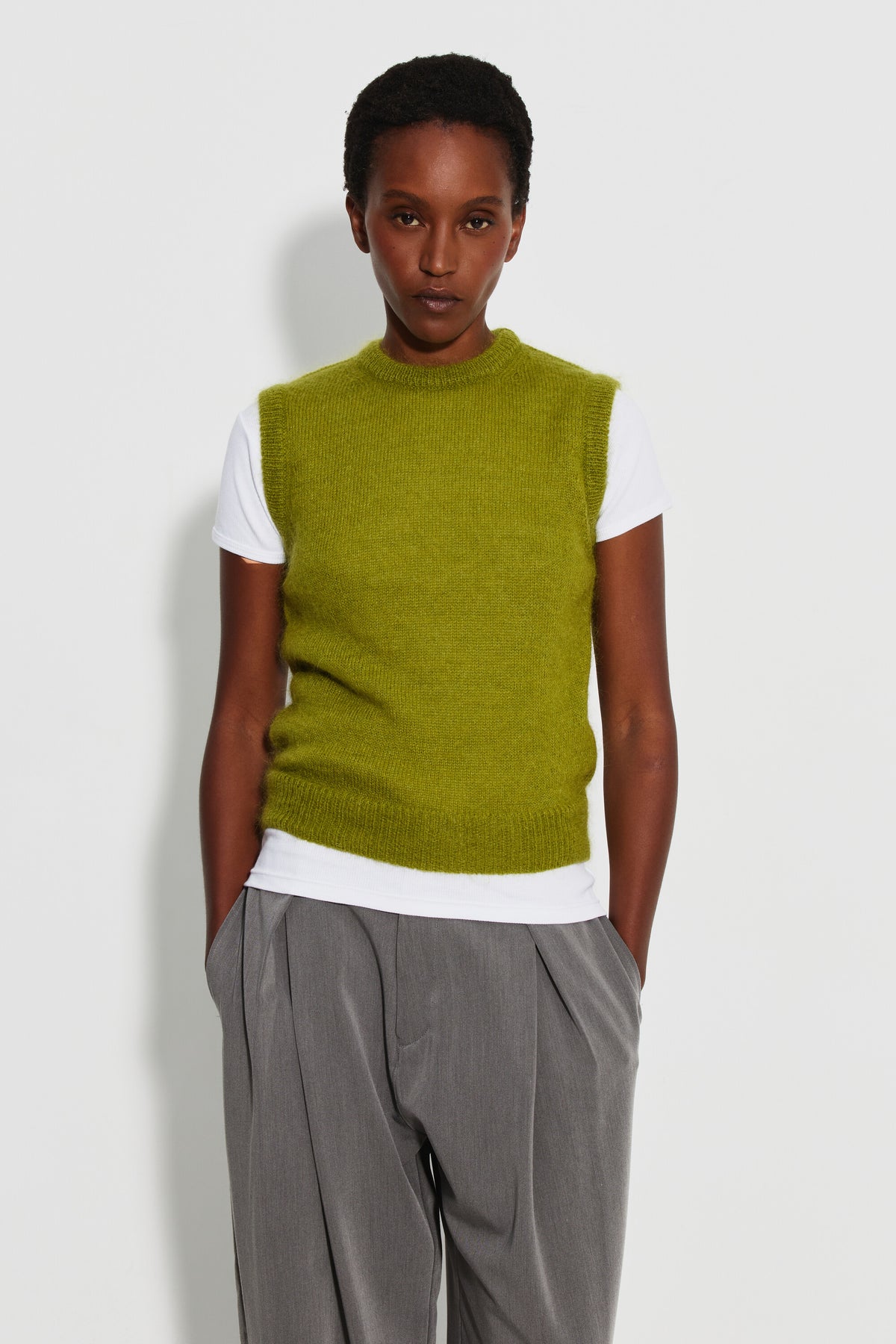 Pull mohair sans manches femme vert mousse – vue de face, porté sur un tee-shirt blanc.