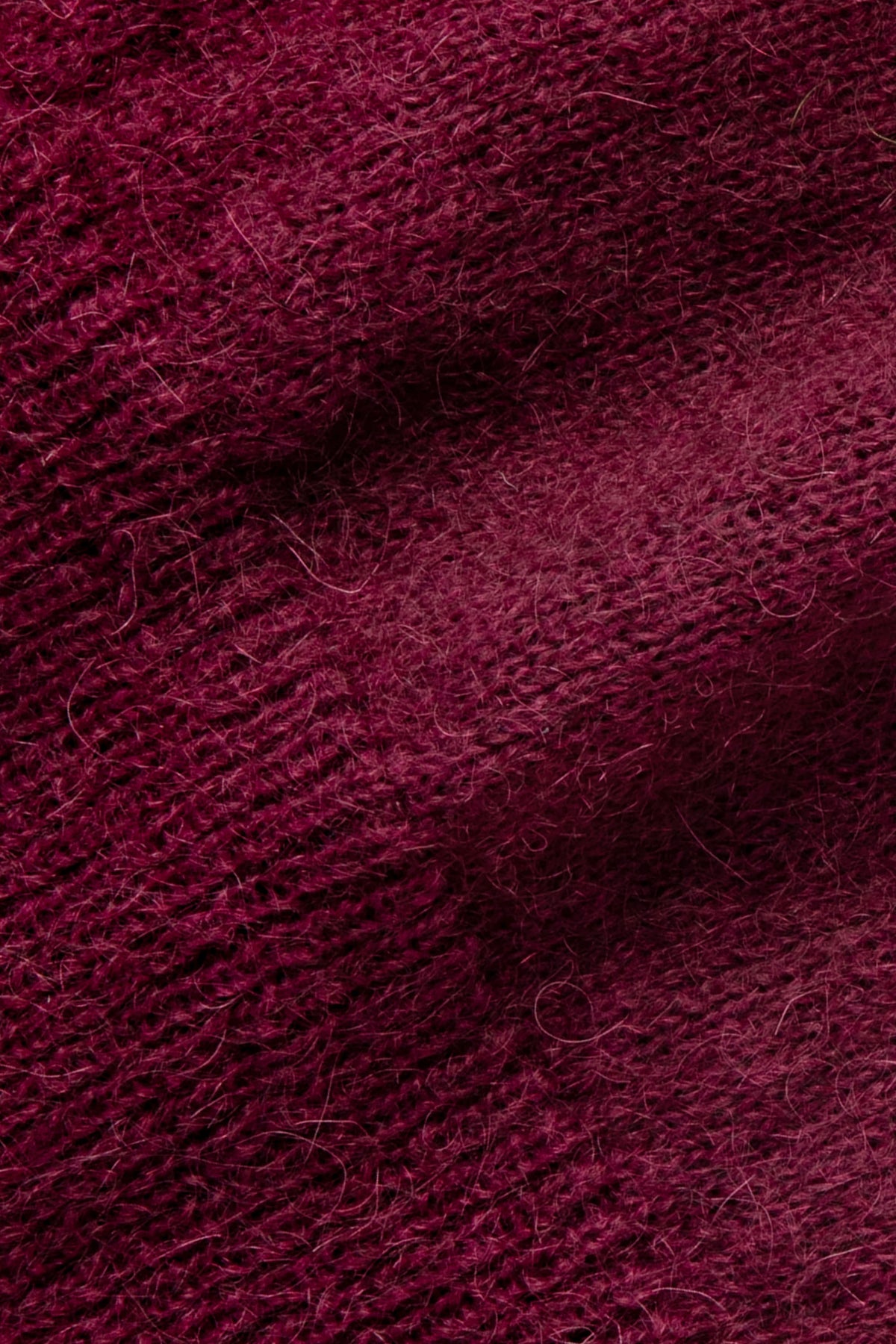 Pull bordeaux en mohair, gros plan sur la maille duveteuse.
